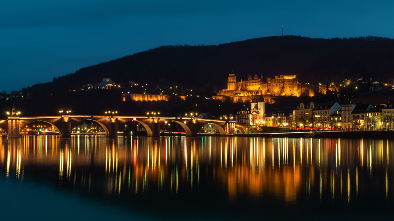 Heidelberger Neckar und Heidelberger Schloss bei Nacht. 